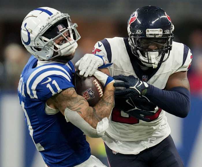 Houston Texans cornerback Desmond King II (25) hits Indianapolis Colts wide receiver Michael Pittman Jr. (11) on Saturday, Jan. 6, 2024, during a game against the Houston Texans at Lucas Oil Stadium in Indianapolis. King received a personal foul for the hit.